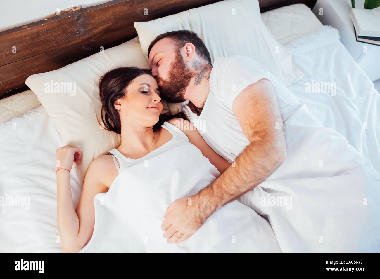 a man and a woman sleeping in beds at home Stock Photo Alamy