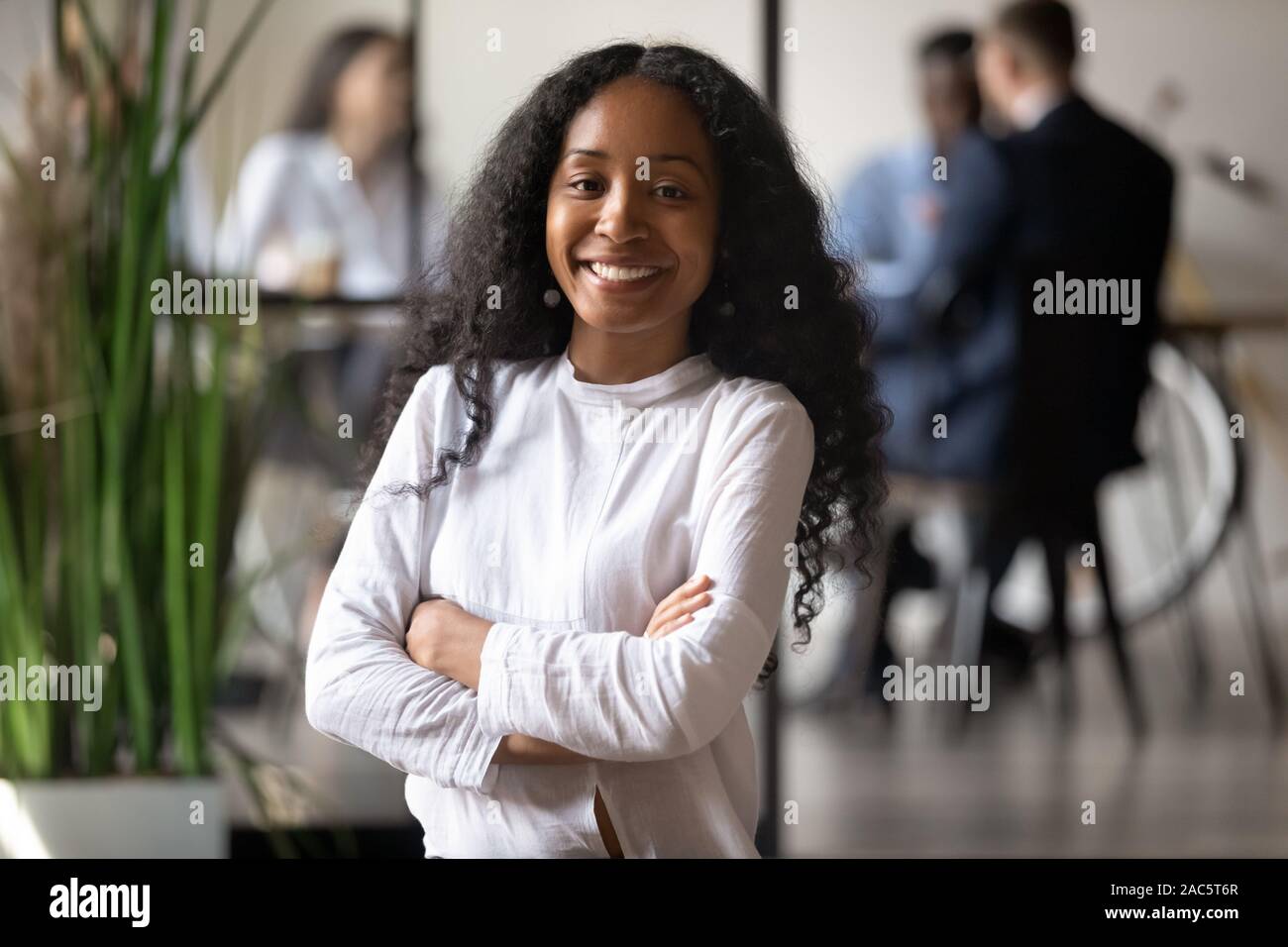 Head shot portrait of smiling young african american female professional. Stock Photo