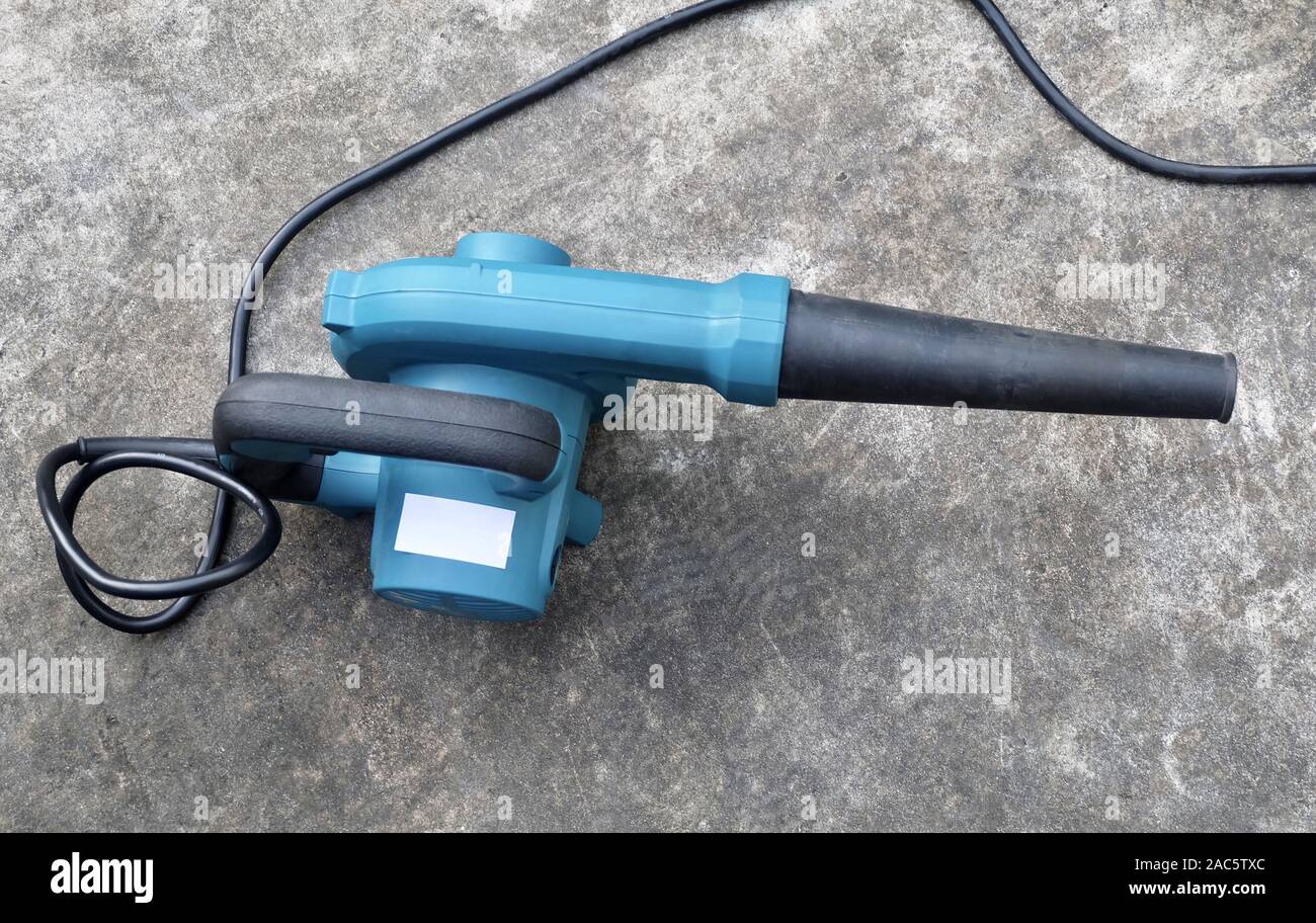 Blue Air Blower on Cement Floor, Use to Remove Dust From The Electrical Machine and Leaves in A Garden. Stock Photo