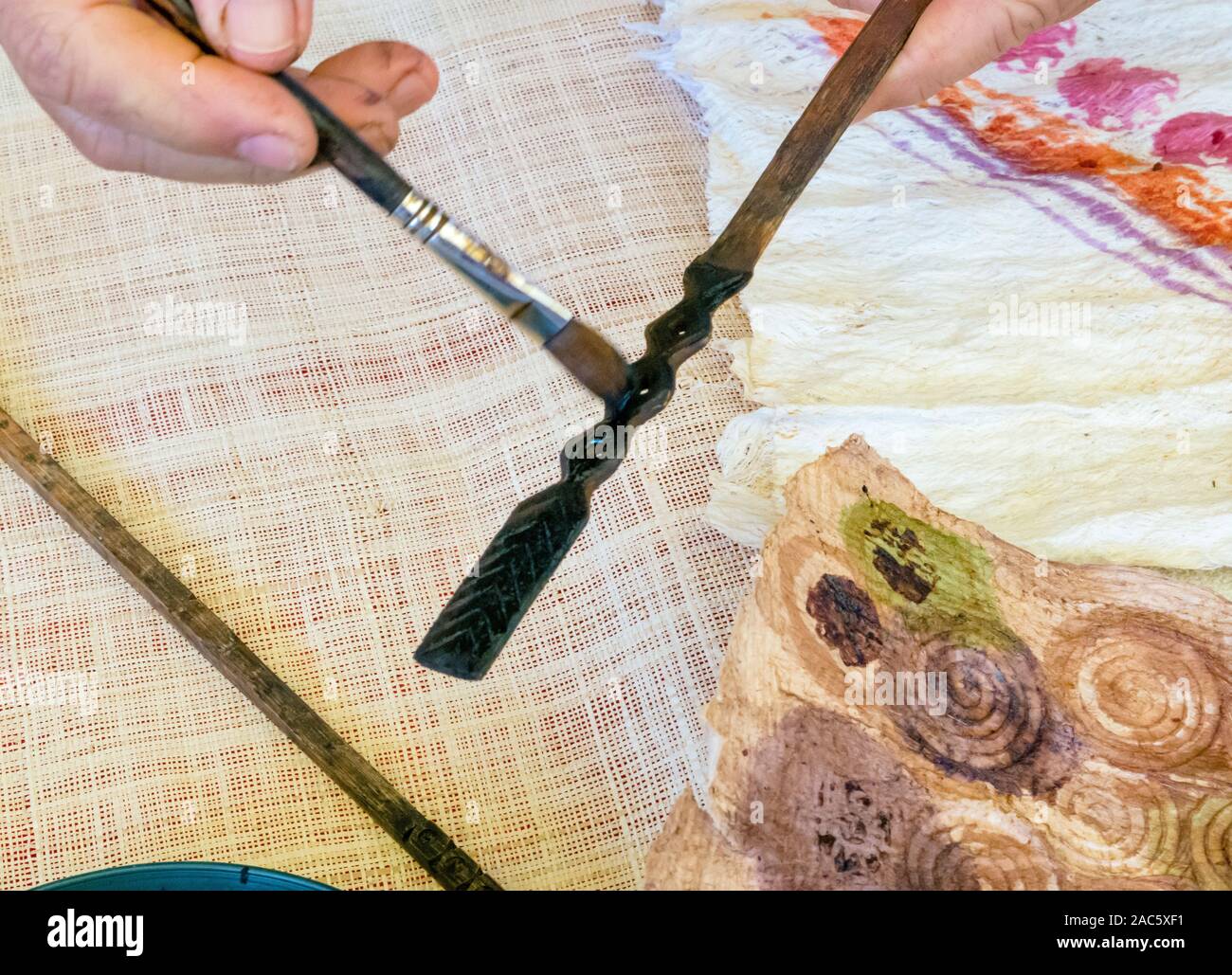 Kapa making on the Big Island A kapa maker brushes black dye made from