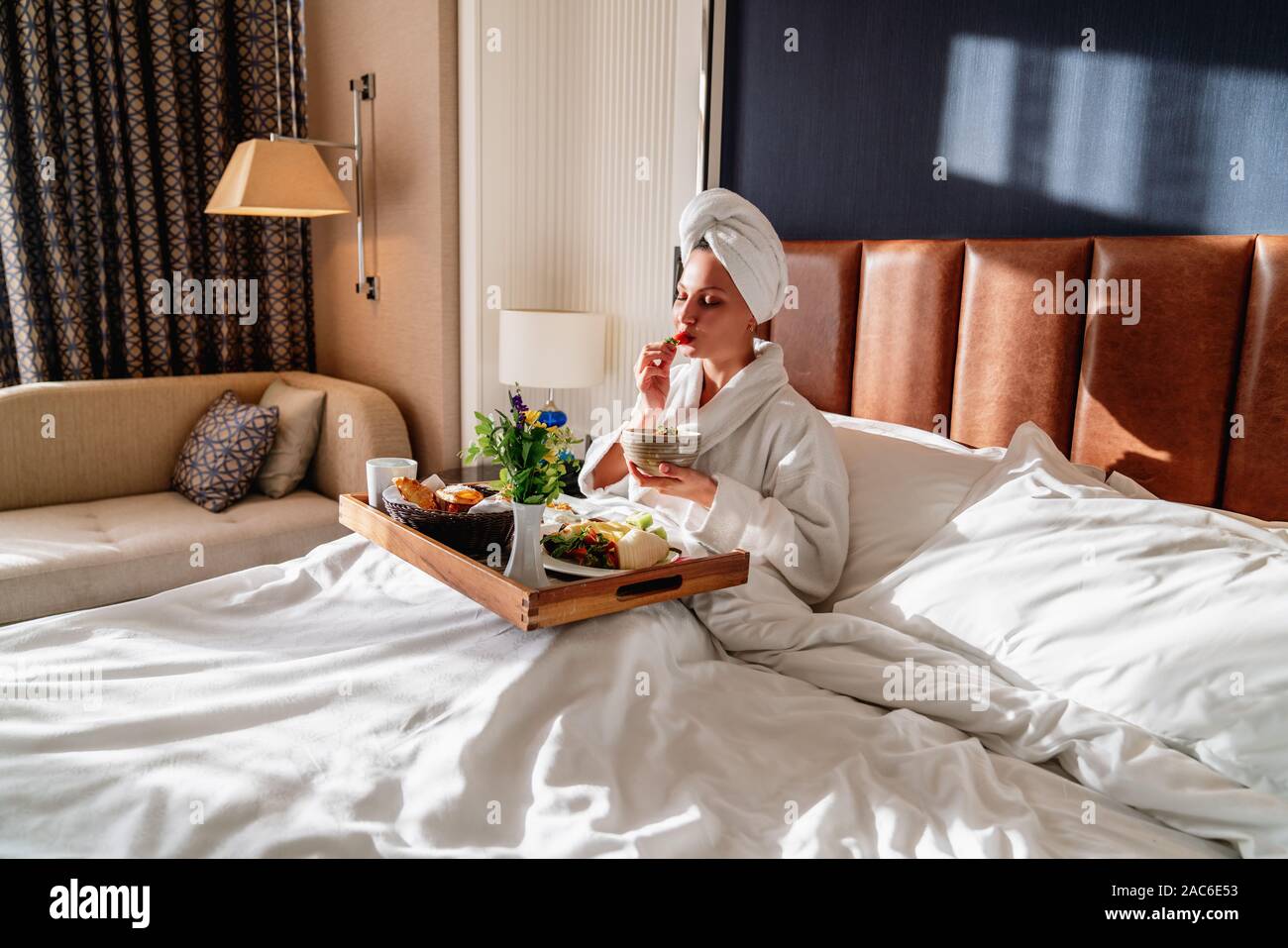 beautiful woman enjoying her morning breakfast in bed Stock Photo