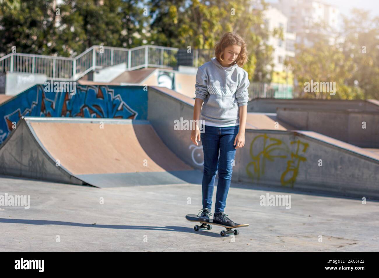 Girl teenager rides on a skateboard 