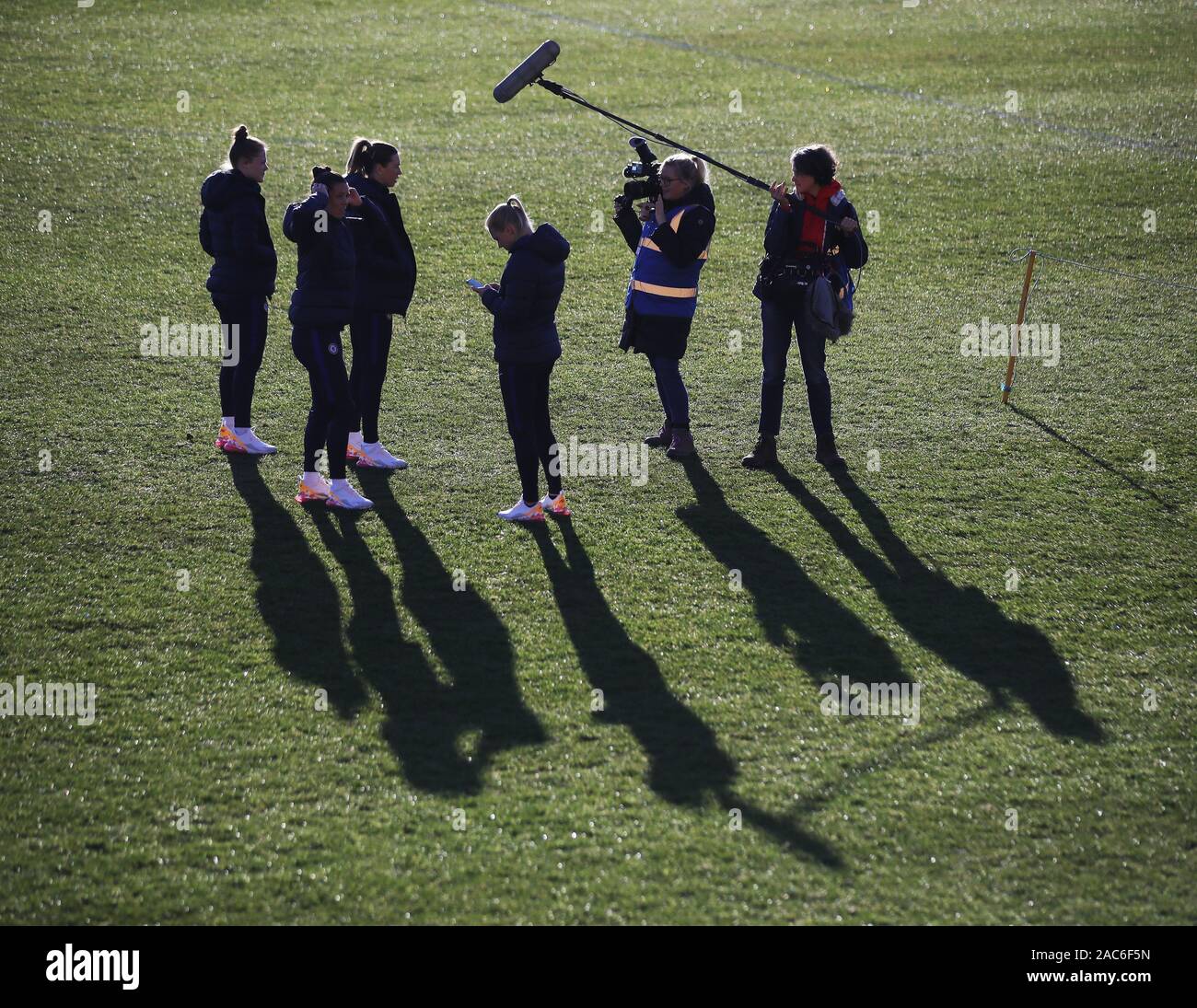 A general view of players waiting during a pitch inspection before the FA Women's Super League match at Haig Avenue, Liverpool. Stock Photo