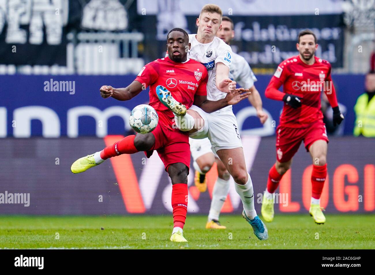 Sandhausen, Germany. 01st Dec, 2019. Soccer: 2nd Bundesliga, SV Sandhausen - VfB Stuttgart, 15th matchday, in Hardtwaldstadion. Stuttgart's Orel Mangala (l) and Sandhausens Aleksandr Zhirov fight for the ball. Credit: Uwe Anspach/dpa - IMPORTANT NOTE: In accordance with the requirements of the DFL Deutsche Fußball Liga or the DFB Deutscher Fußball-Bund, it is prohibited to use or have used photographs taken in the stadium and/or the match in the form of sequence images and/or video-like photo sequences./dpa/Alamy Live News Stock Photo