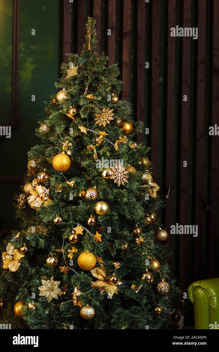 green Christmas tree decorated with Golden yellow cones ornaments ...