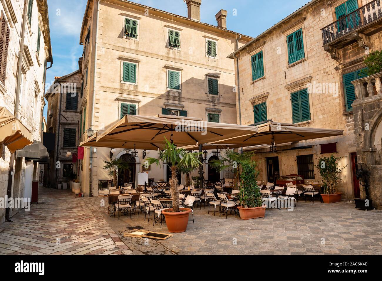 Cafe tables on cozy street of old town. Kotor, Montenegro Stock Photo