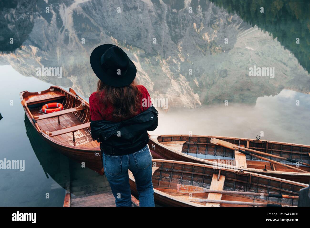 Reflections in the water looks like real ones. Woman in black hat ...