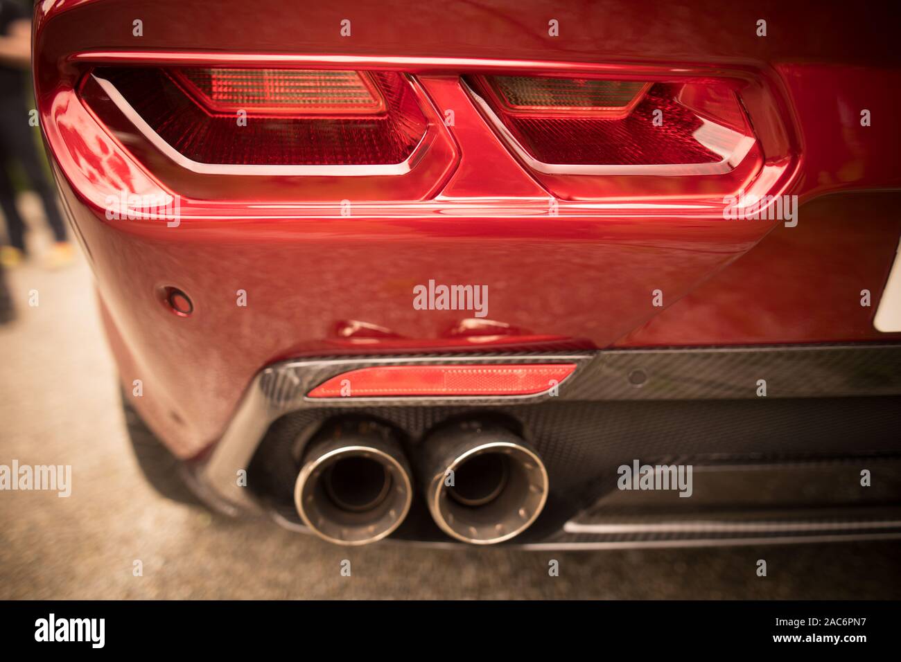 Close up horizontal image of the LED tail lights and exhaust pipes of a