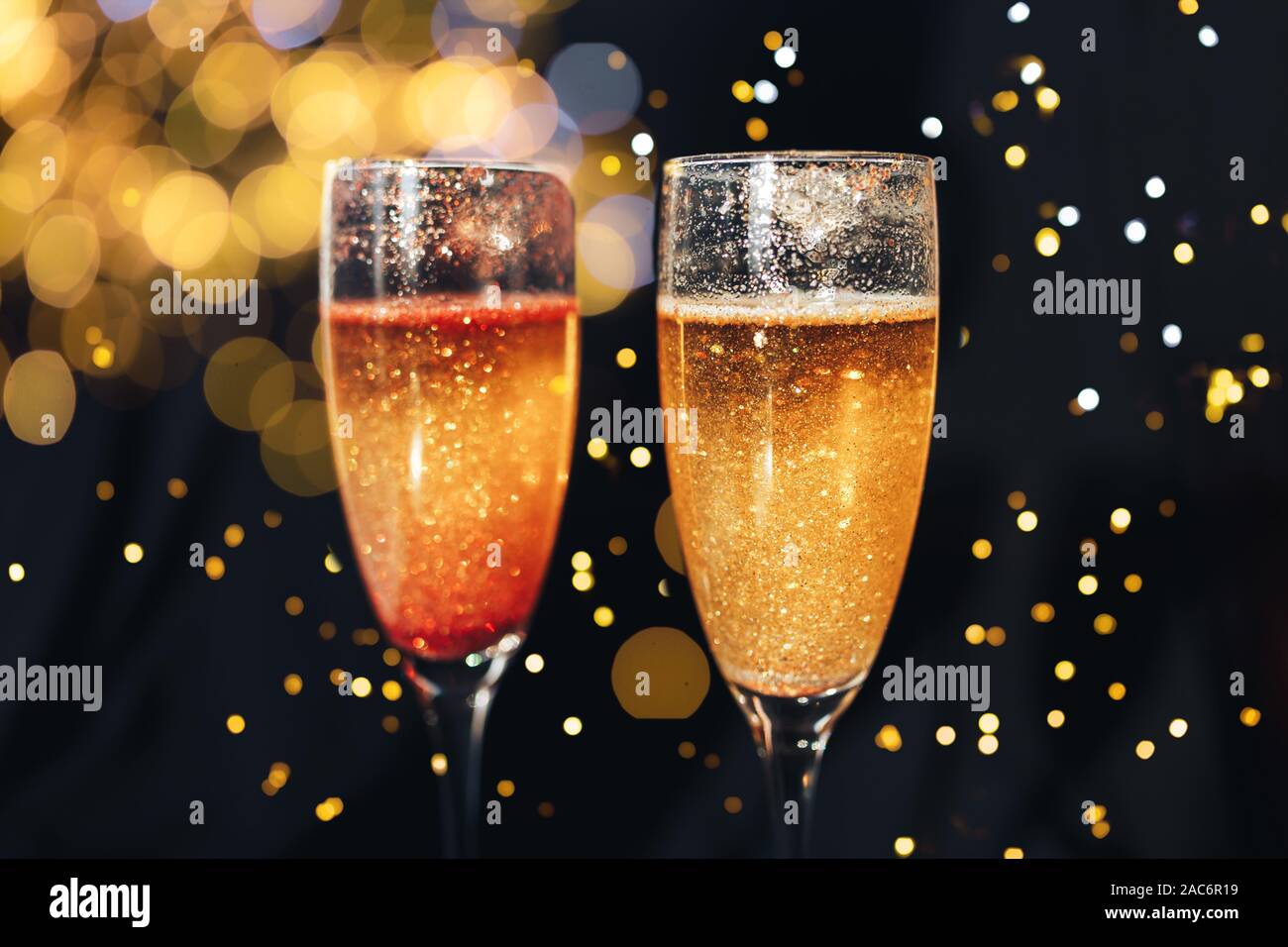 Two champagne glasses splash with drops hi-res stock photography and ...