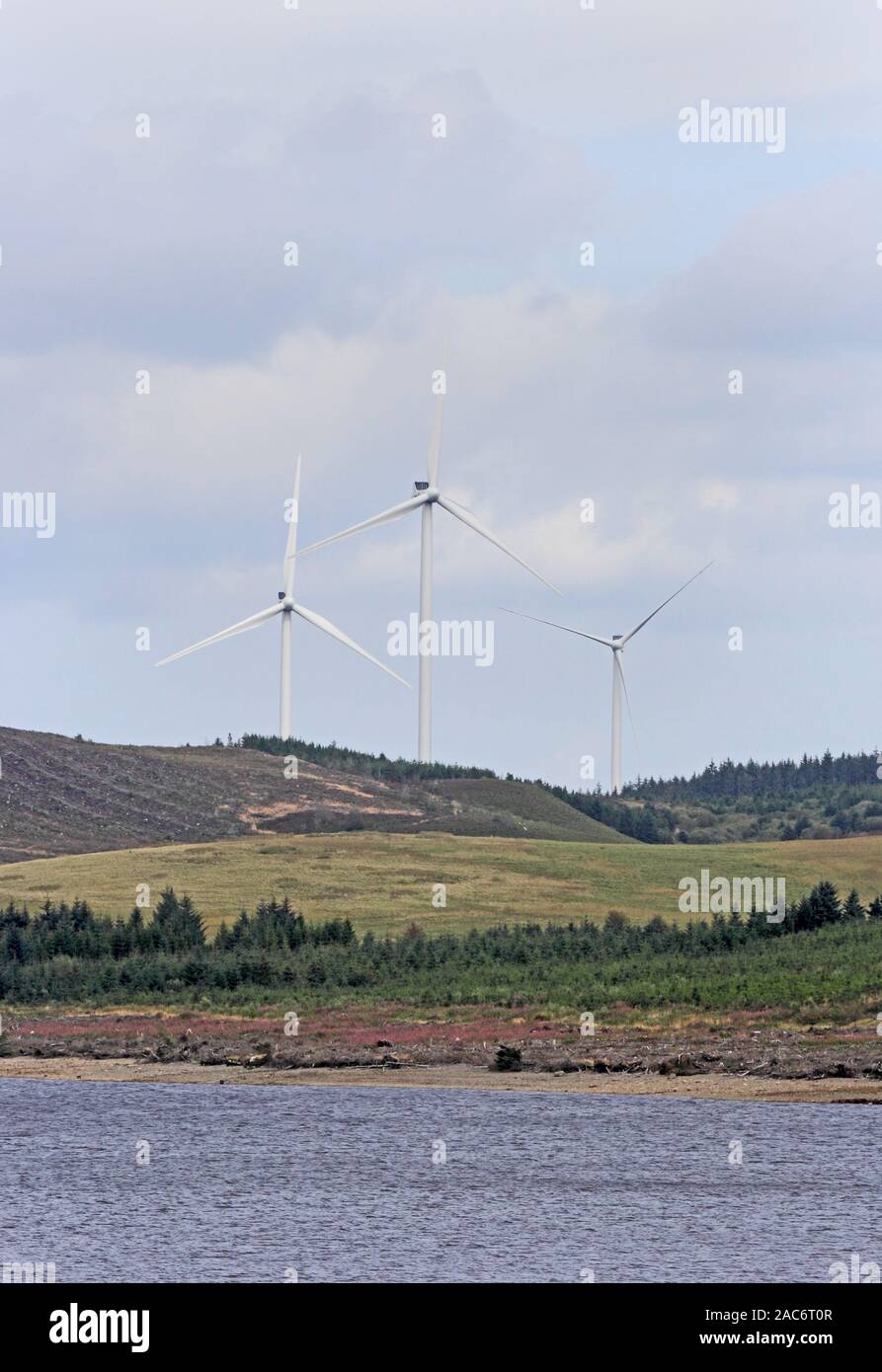 Llyn Brenig Wind Farm, with reservoir in foreground. Stock Photo