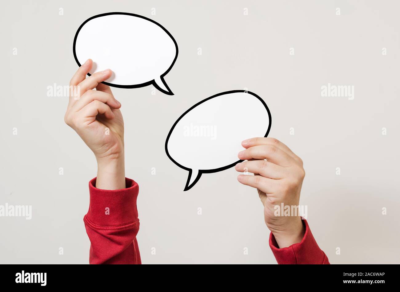 Hand holding two blank speech bubble sign ready for message Stock Photo