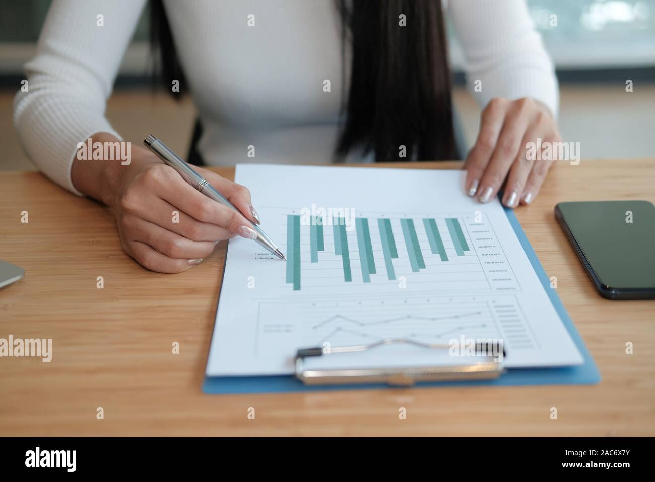 businesswoman working with document at office. startup woman entrepreneur analyzing financial performance at workplace. student studying doing assignm Stock Photo