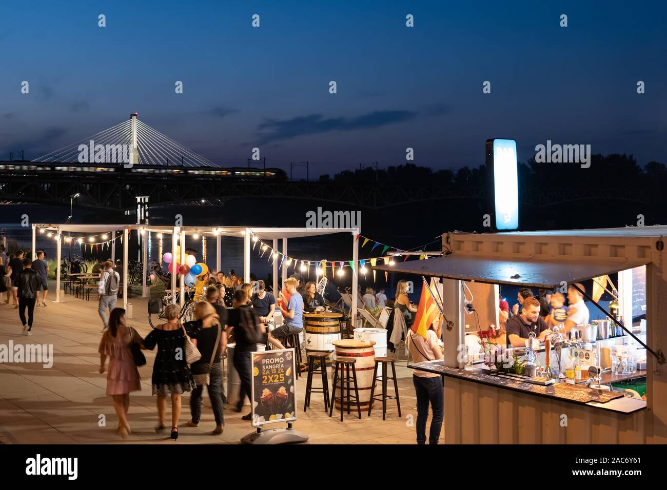 People at cafe restaurant on Vistula River Boulevards at night in city of Warsaw in Poland Stock Photo