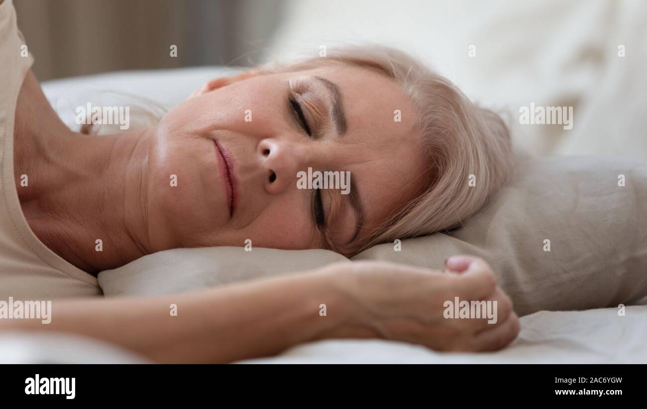 Close up view sleeping middle-aged woman lying on pillow Stock Photo