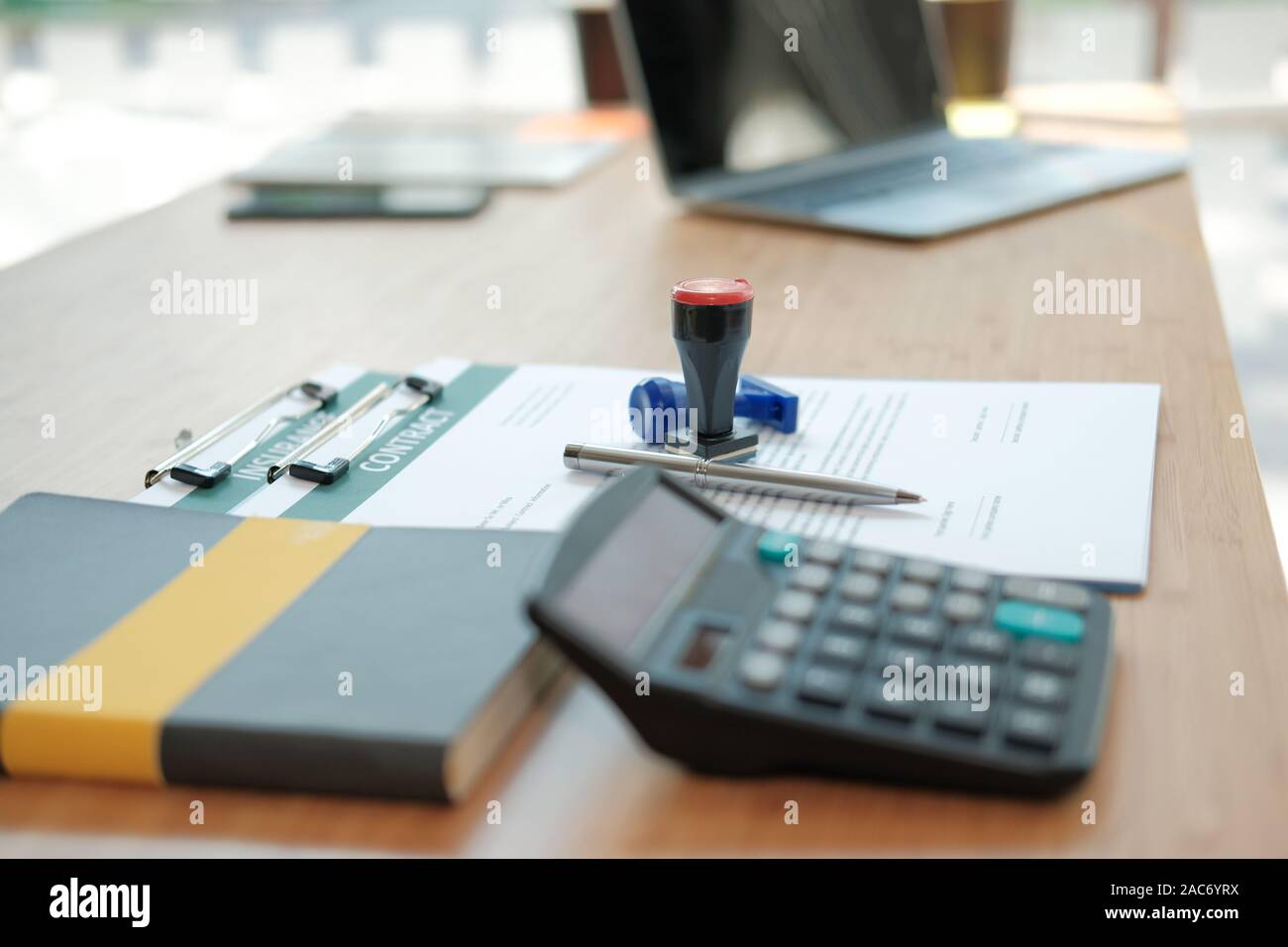 stamper insurance contract document on lawyer broker realtor real estate agent office desk Stock