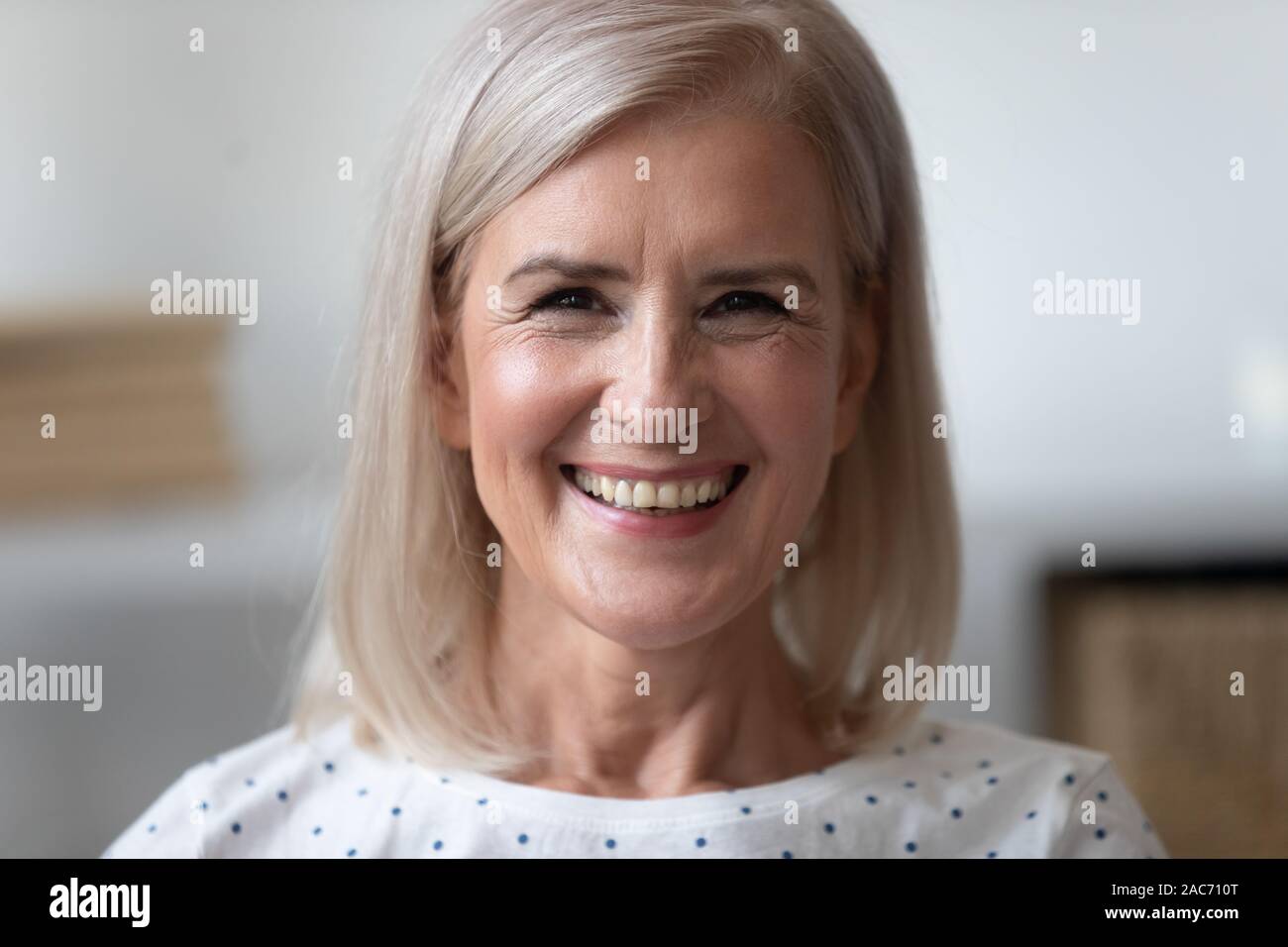 Close up portrait beautiful cheery older woman Stock Photo