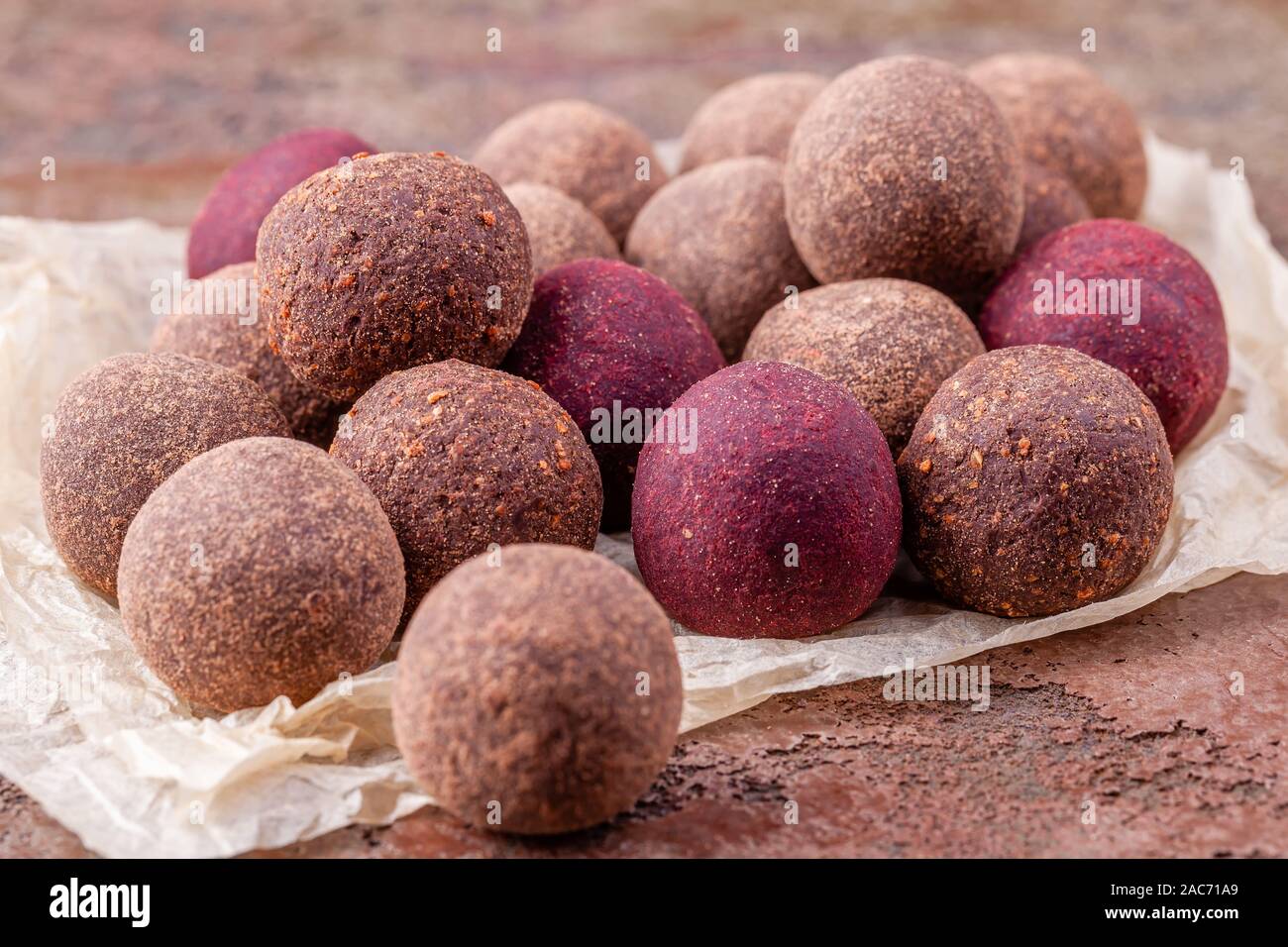 Close Up of Homemade Raw Vegan Cocoa Energy Balls on Craft Paper Stock Photo