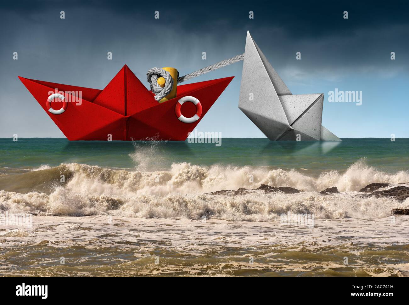 Rescue concept. Red paper rescue boat of the coast guard towing a white boat that are sinking, in a rough sea with wave and sky with rain Stock Photo