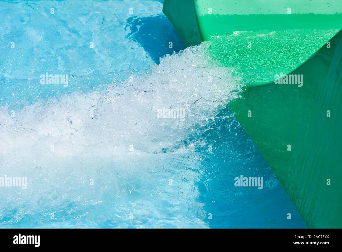 Green water park slide and swimming pool. Aqua park background Stock