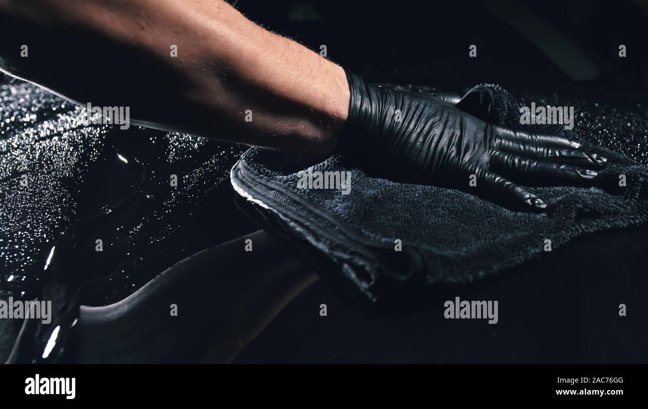 Using rag in palm of your hand, drops are removed from the car. Drop ...