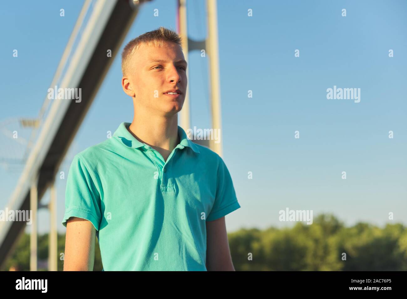 Outdoor portrait of young blond male, serious confident teenager ...