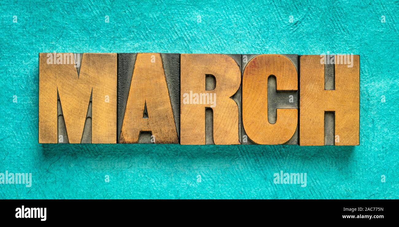 March month banner - word in vintage letterpress wood type against  turquoise  handmade textured paper - calendar concept Stock Photo