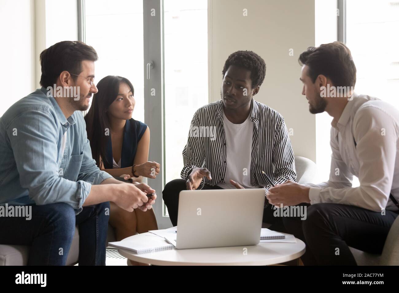 American supervisor give instructions to multiracial corporate staff Stock Photo