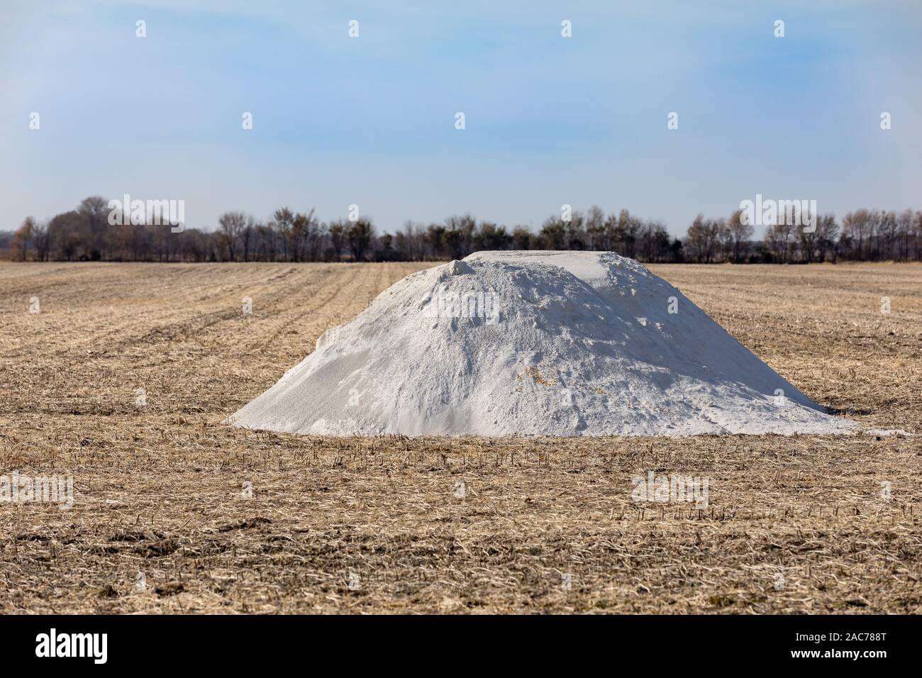 Pile of pulverized agriculture lime, limestone, fertilizer in soybean farm field stubble waiting for fall application Stock Photo