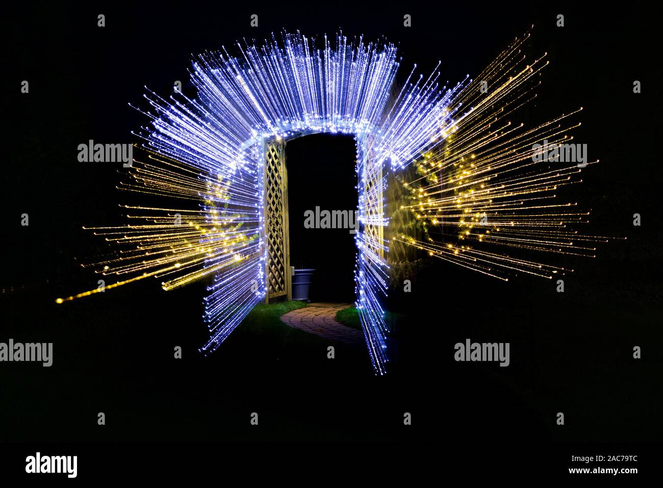 Christmas lights illuminating garden archway Stock Photo Alamy