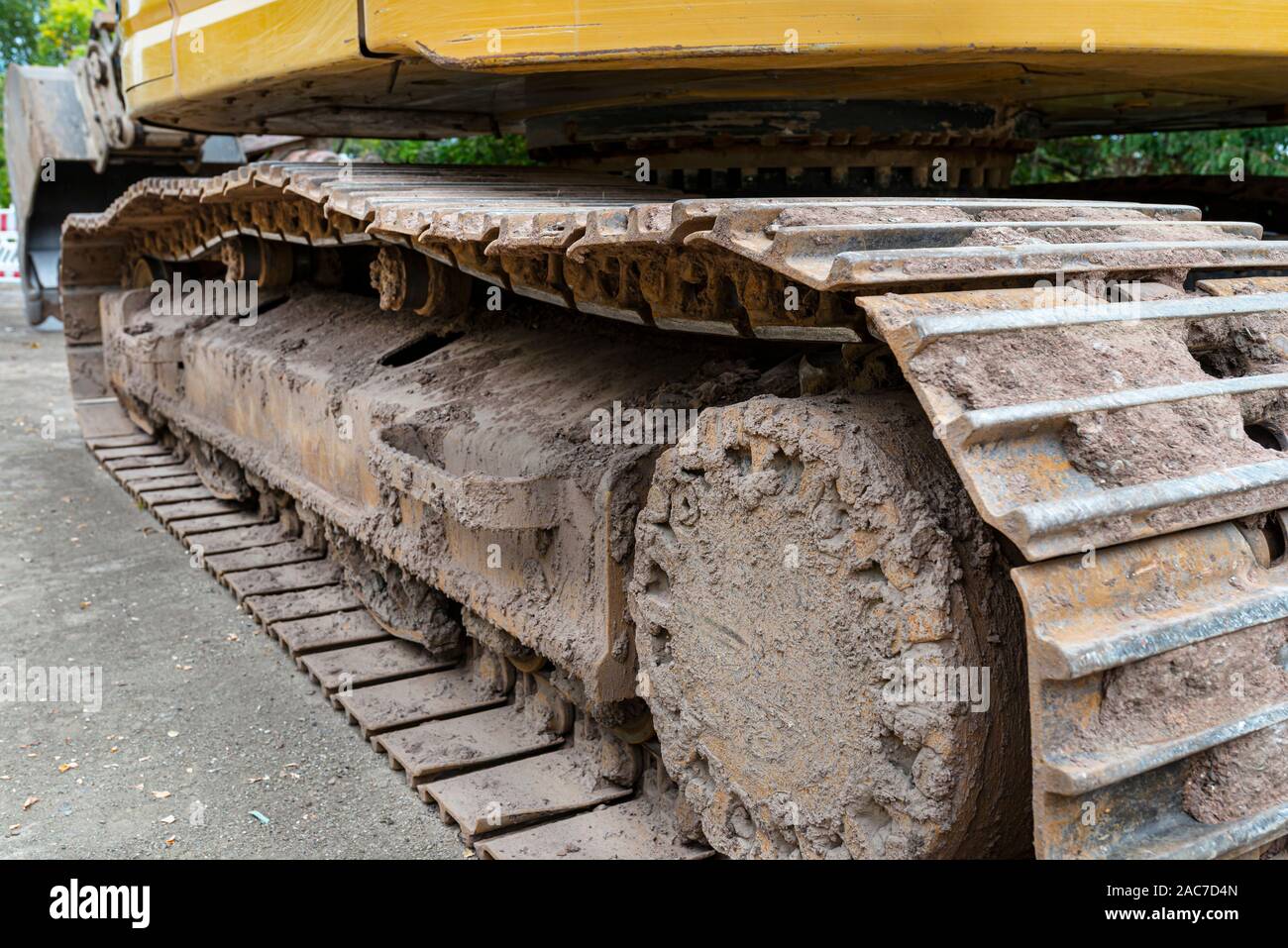 Metal track drive of a large excavator, visible up close. Stock Photo