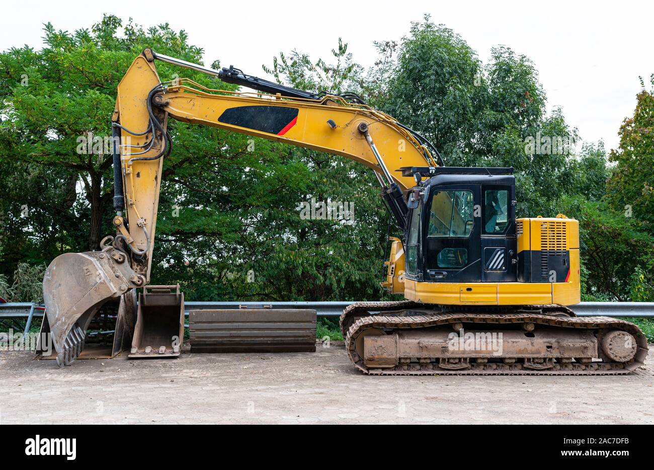 Download A Large Excavator In Yellow Color Visible From The Profile With A Lowered Bucket Stock Photo Alamy Yellowimages Mockups