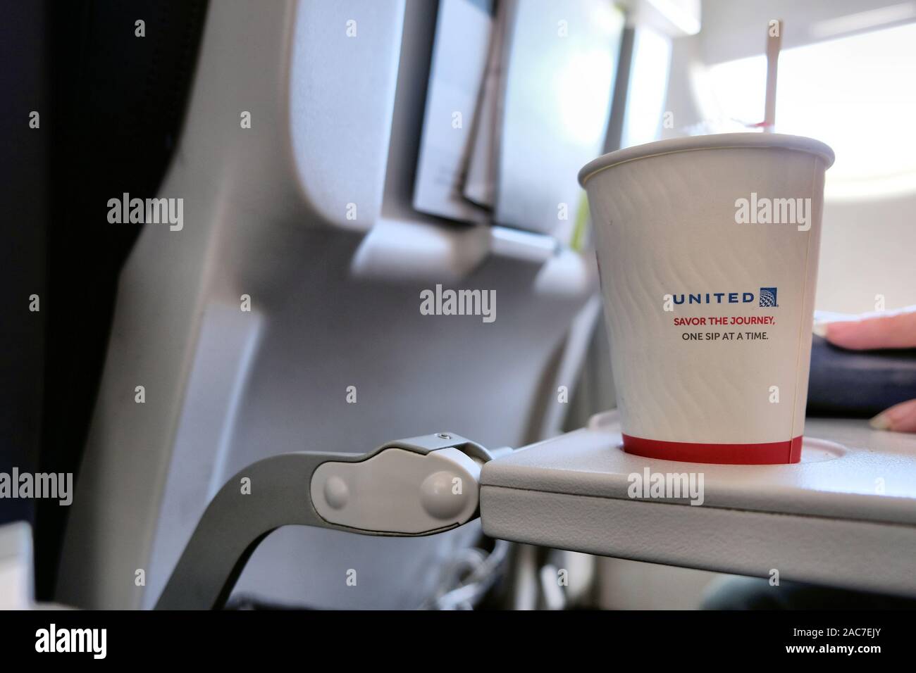 United Airlines coffee cup with logo and Savor the Journey One Sip at a