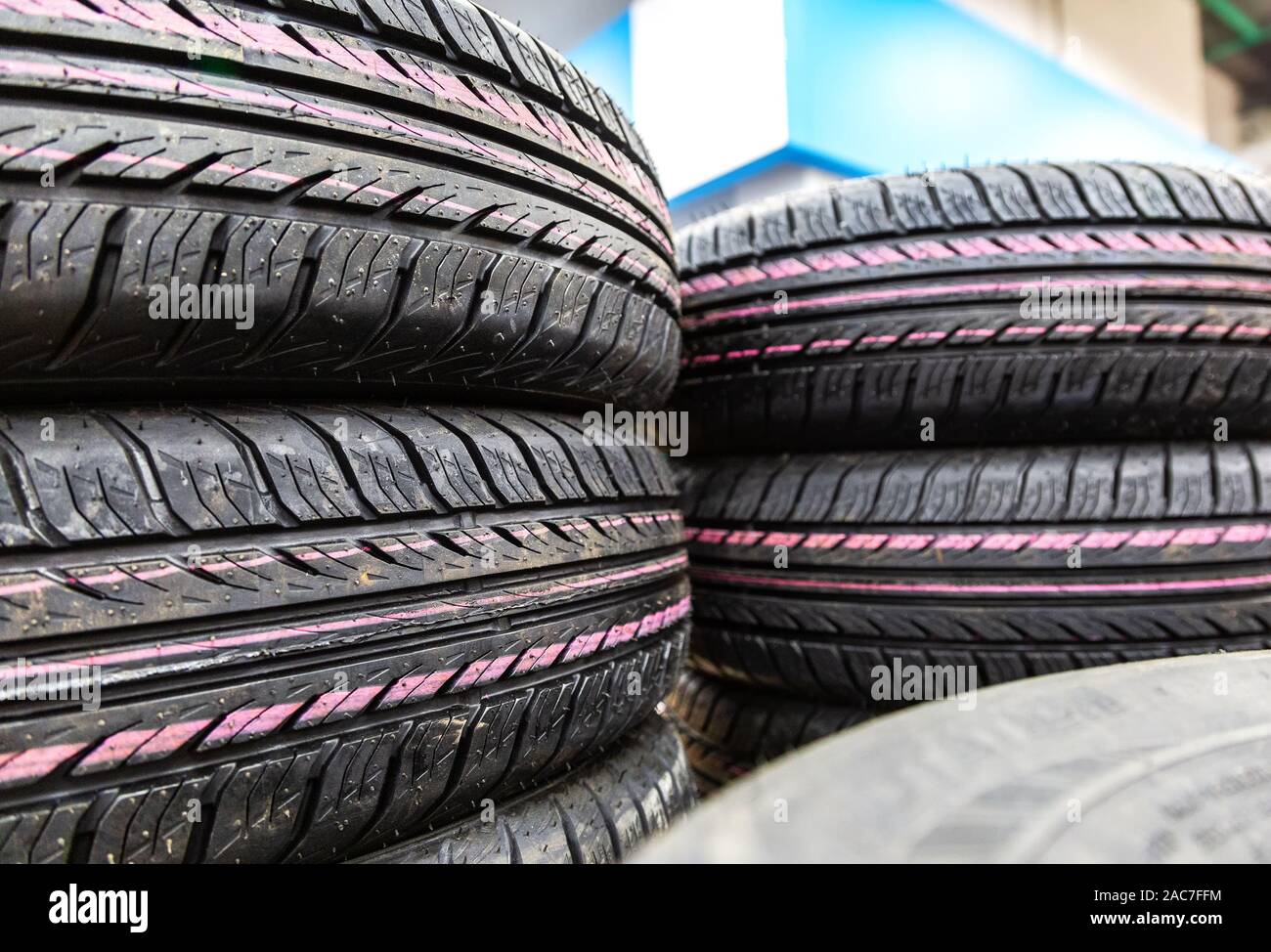 Summer vehicle tires stacked up for sale at the store. New tyres for