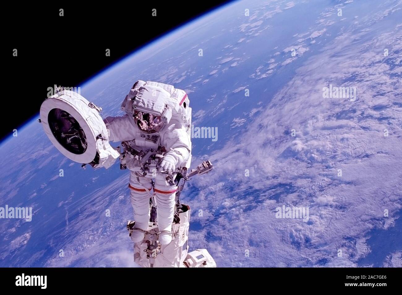 Astronaut at the space station is engaged in repairs. Elements of this  image were furnished by NASA. For any purpose Stock Photo - Alamy