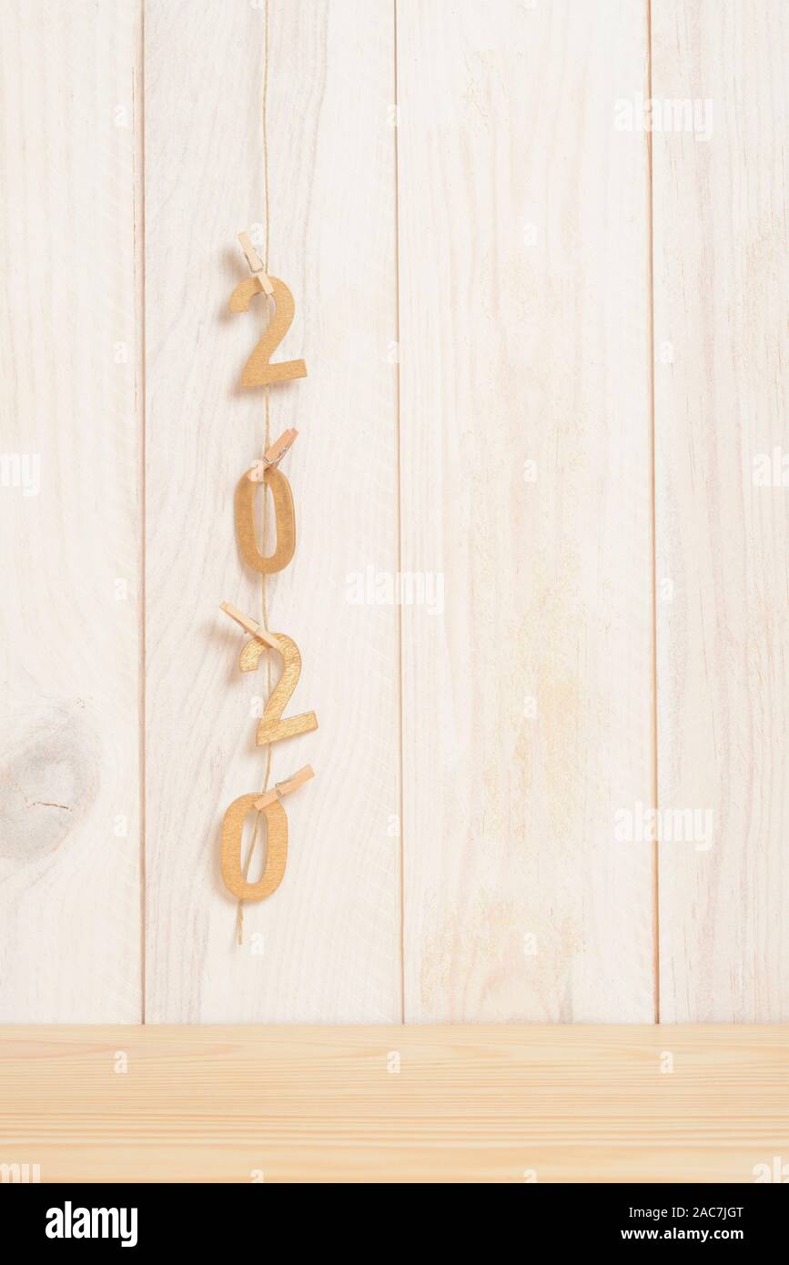 New year 2020 in golden wood numbers hanging on a rope subjects with ...