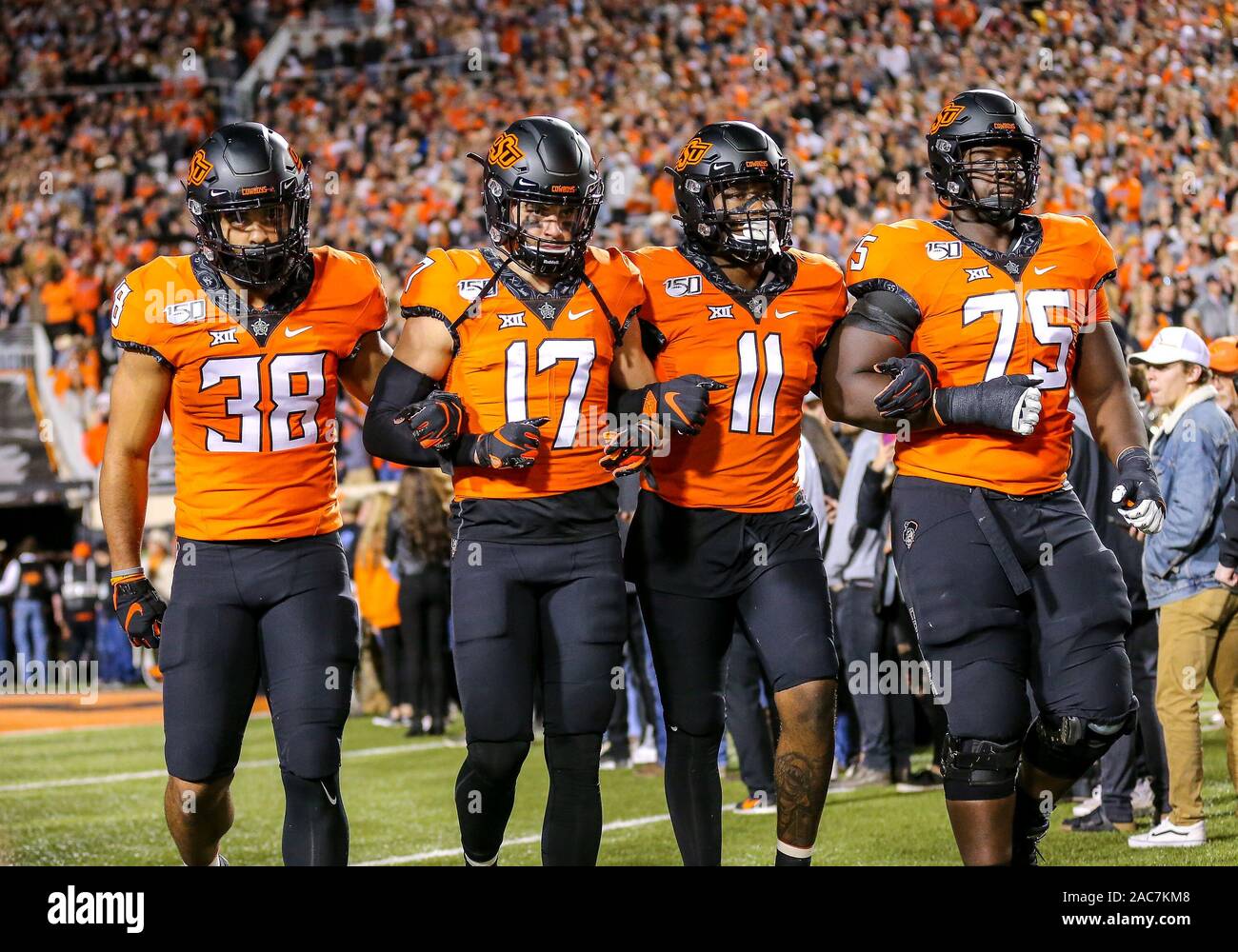 November 30, 2019: Oklahoma State teammates Philip Redwine-Bryant (38), David Thibodeaux-Benoit (17), Amen Ogbongbemiga (11), and Marcus Keyes (75) take the field before a football game between the University of Oklahoma Sooners and the Oklahoma State Cowboys at Boone Pickens Stadium in Stillwater, OK. Gray Siegel/CSM Stock Photo