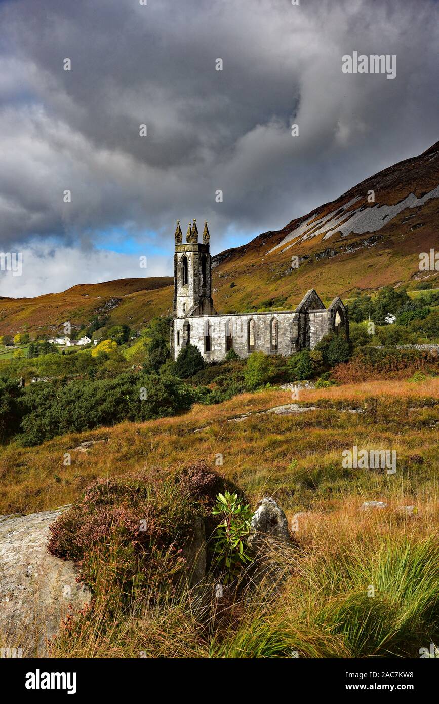 Ominous clouds circle derelict Dunlewey Church at the foot of Mount Errigal, the tallest peak of the Derryveagh Gaeltacht, Poisoned Glen, Ireland. Stock Photo
