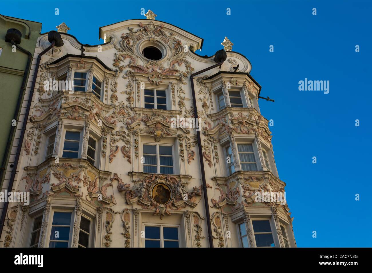 Helbling house in Innsbruck. This house presenting windows frames and a very decorated pediment - INNSBRUCK, Austria - October 26, 2019. Stock Photo