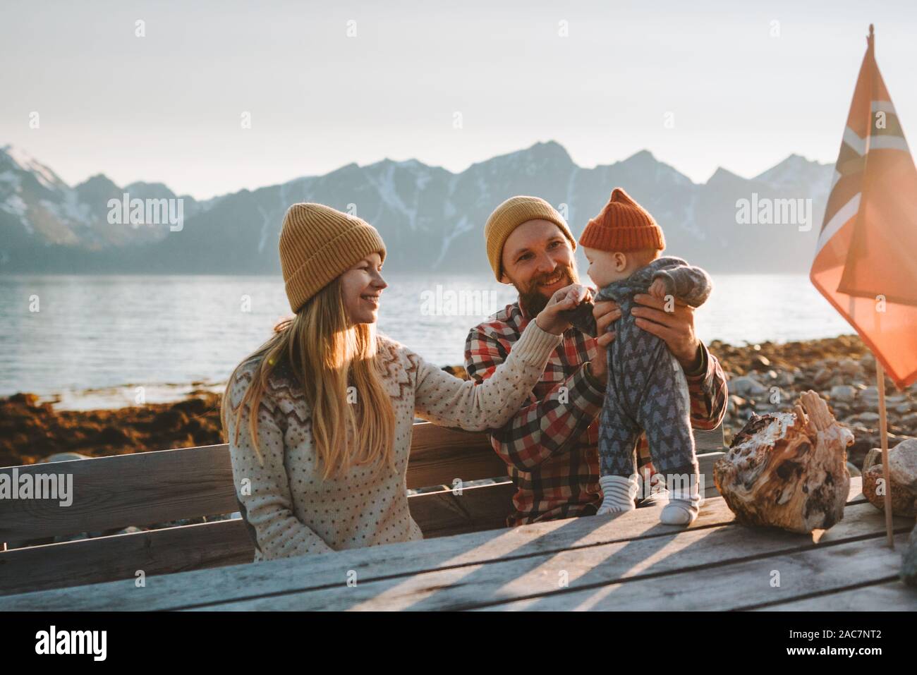 Happy family outdoor mother and father with baby together vacations parents with child healthy healthy lifestyle mountains view travel in Norway Stock Photo
