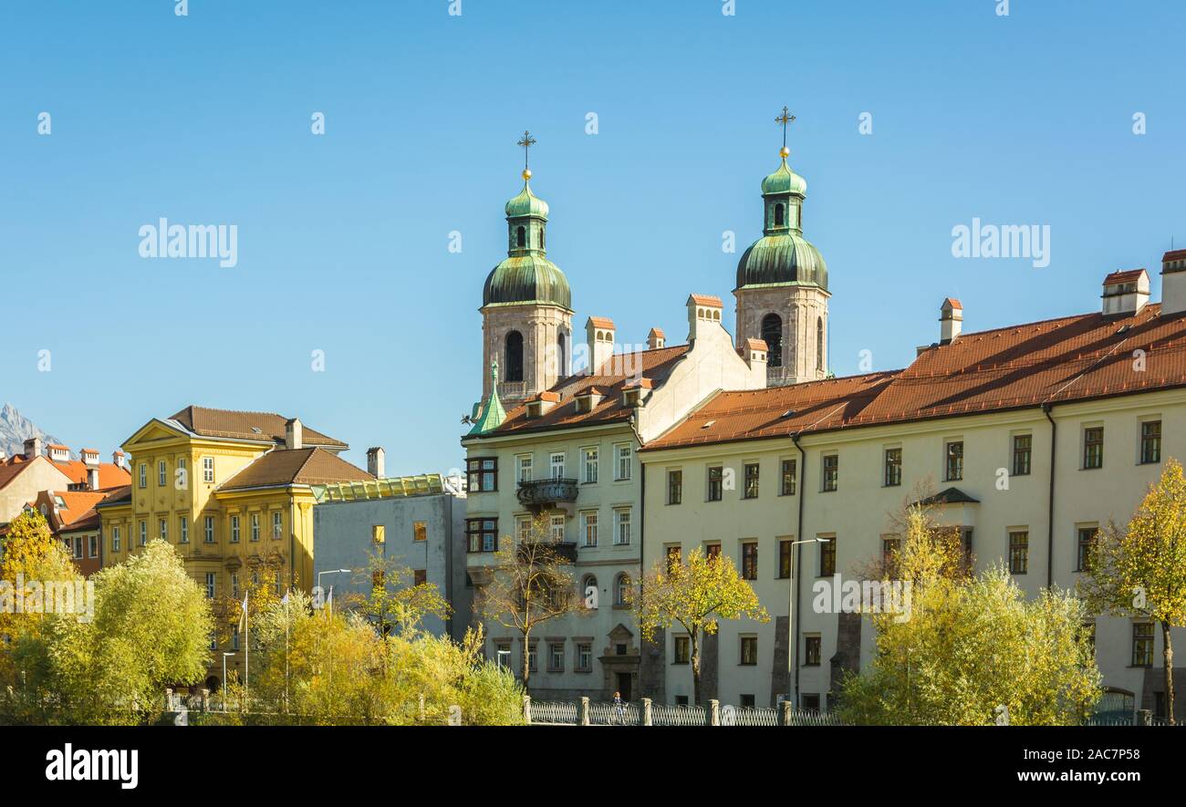 NNSBRUCK, AUSTRIA - October 26, 2019: View of the old palaces with the San Giacomo Cathedral towers on the Inn river bank - Innsbruck, Tyrol Austria Stock Photo