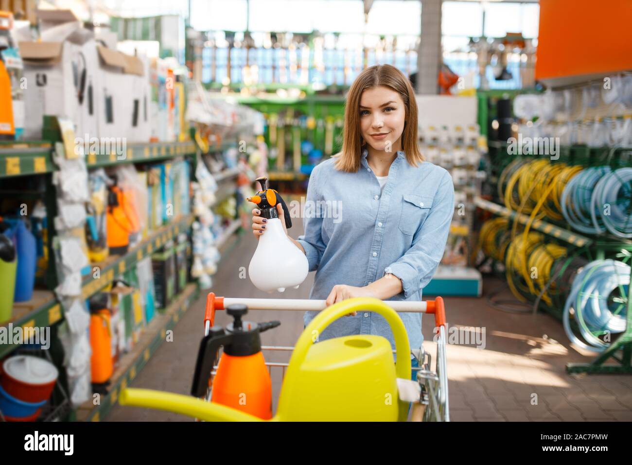 Female customer choosing tools, shop for gardeners Stock Photo