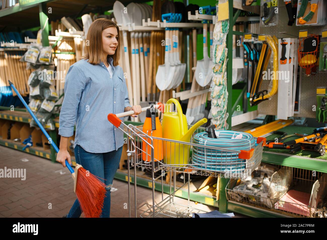 Female consumer choosing tools, shop for gardeners Stock Photo