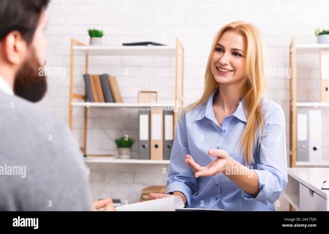 Cheerful psychologist giving advice to male patient Stock Photo Alamy