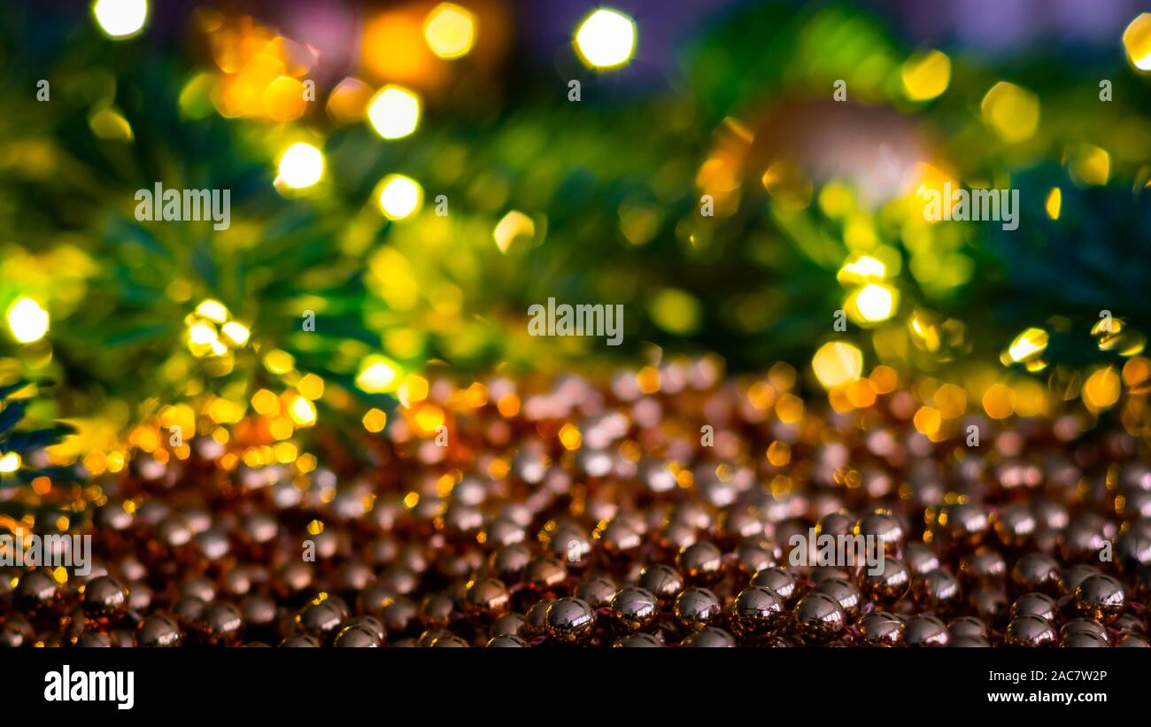 Christmas landscape with shiny balls from a Christmas chain with a blurred  background of Christmas lights and Christmas tree branches Stock Photo -  Alamy