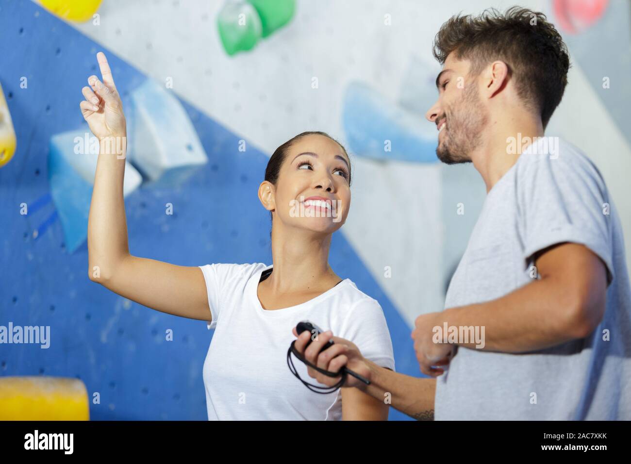 instructor with athlete by interior climbing wall Stock Photo - Alamy