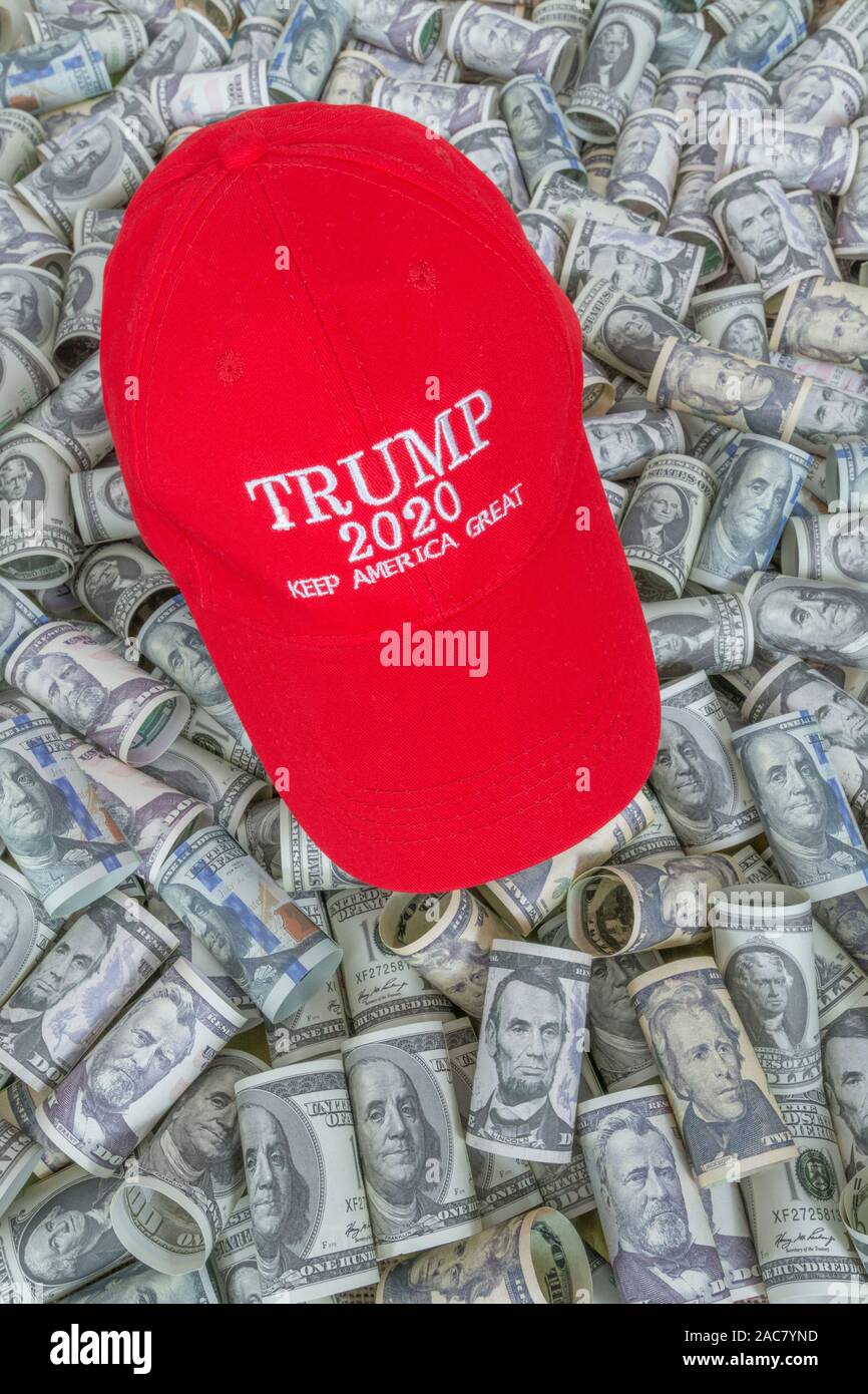 Red Trump KAG / Keep America Great cap hat + Dollar bills (See NOTES). For booming U.S. economy / the Trump Economy, Trump tax cuts, 2020 US Election. Stock Photo