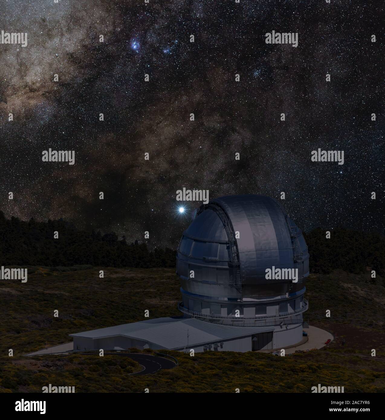 Astronomical Observatory under the bright stars. Milky Way galaxy on the dark sky. Tower and silver blue dome of huge telescope are aimed at celestial Stock Photo