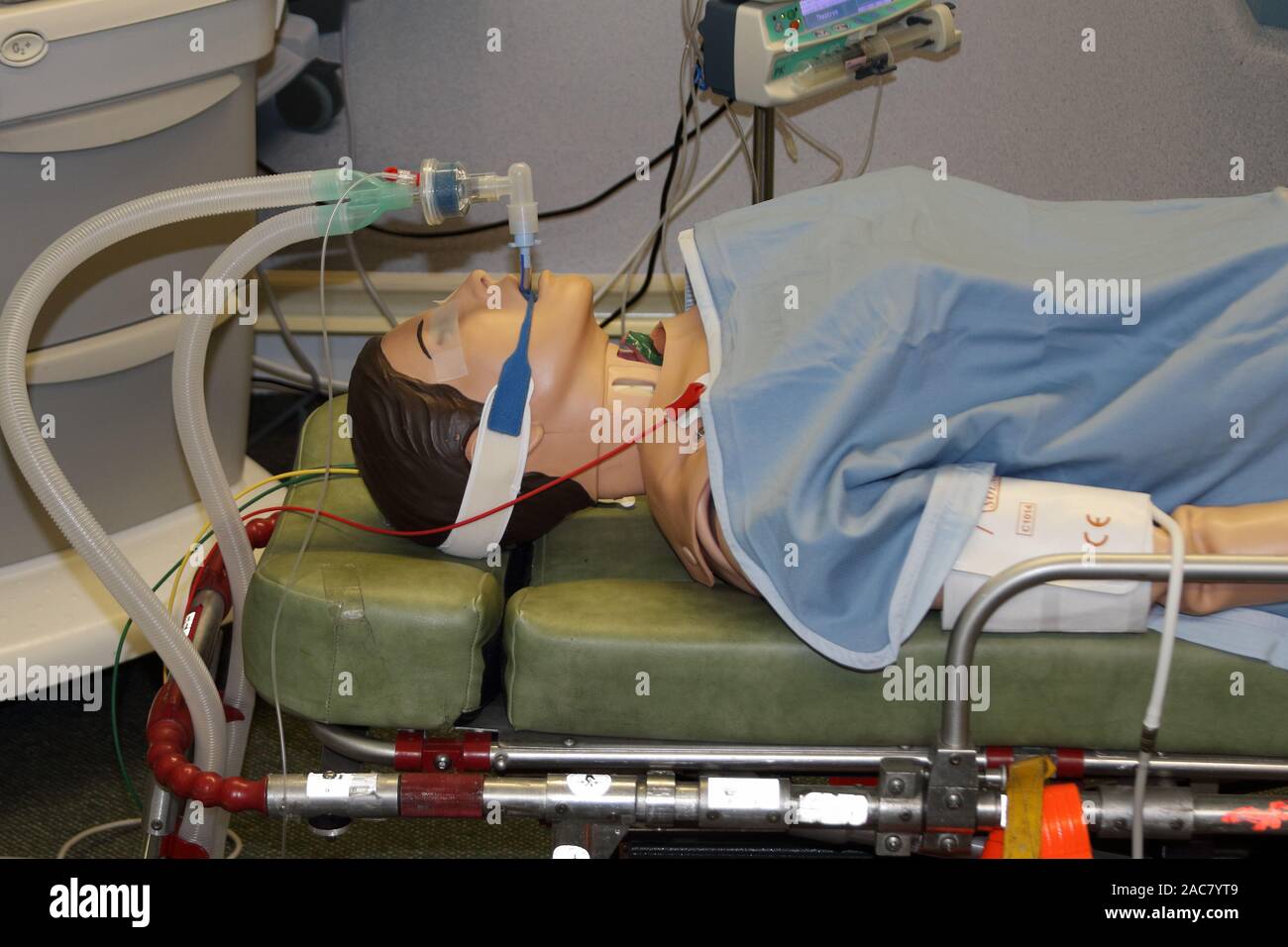 simulated intubated patient on a trolley with equipment in the background Stock Photo