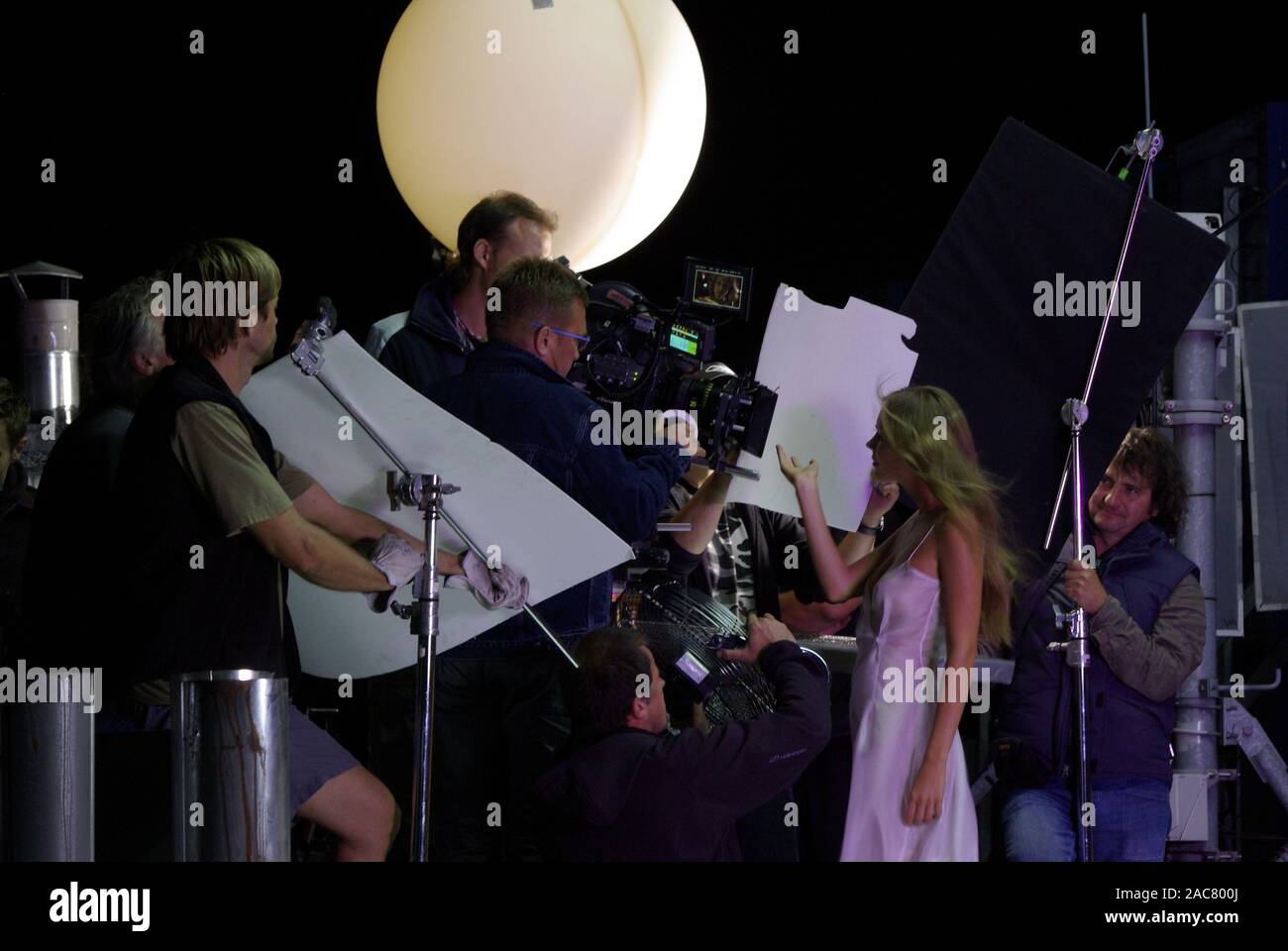 Film crew and actress during the implementation of the advertising film Stock Photo