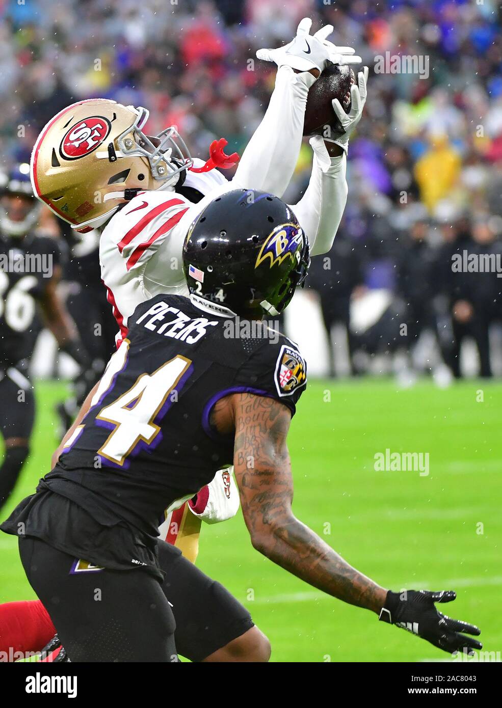 Baltimore Ravens cornerback Marcus Peters (24) looks on during pre-game  warm-ups before an NFL football game against the Carolina Panthers, Sunday,  Nov. 20, 2022, in Baltimore. (AP Photo/Terrance Williams Stock Photo 